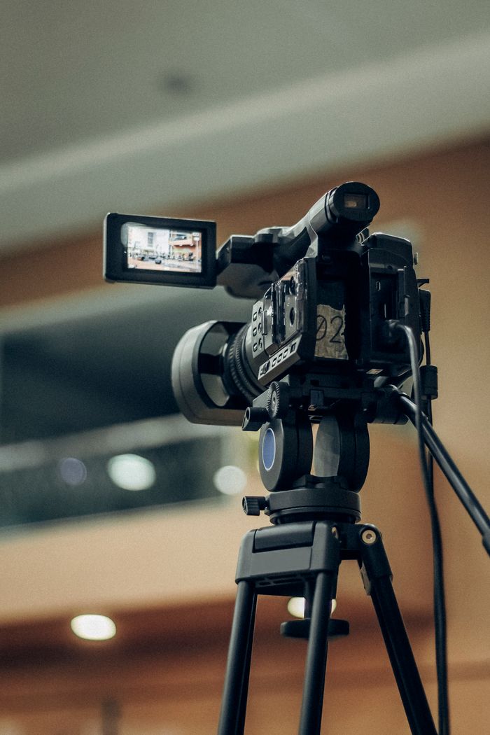 The Art of Drawing Readers In: Your attractive post title goes here A high-quality video camcorder setup on a tripod for indoor filming.
